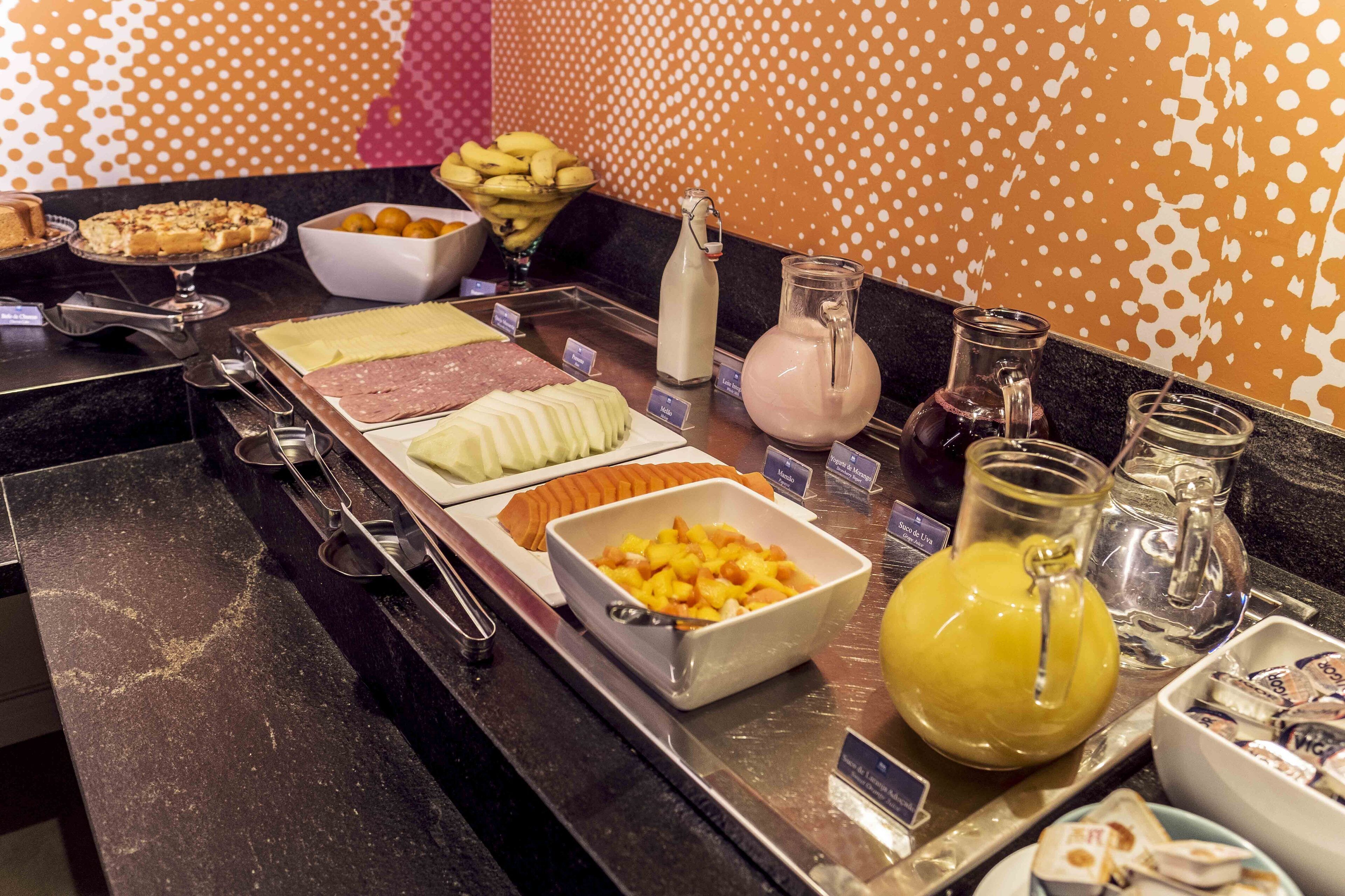 A buffet with various food items and beverages.