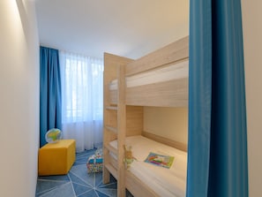A bunk bed room with a small desk, a globe, and a colorful bag. - ibis Styles Bad Reichenhall (Bad Reichenhall)