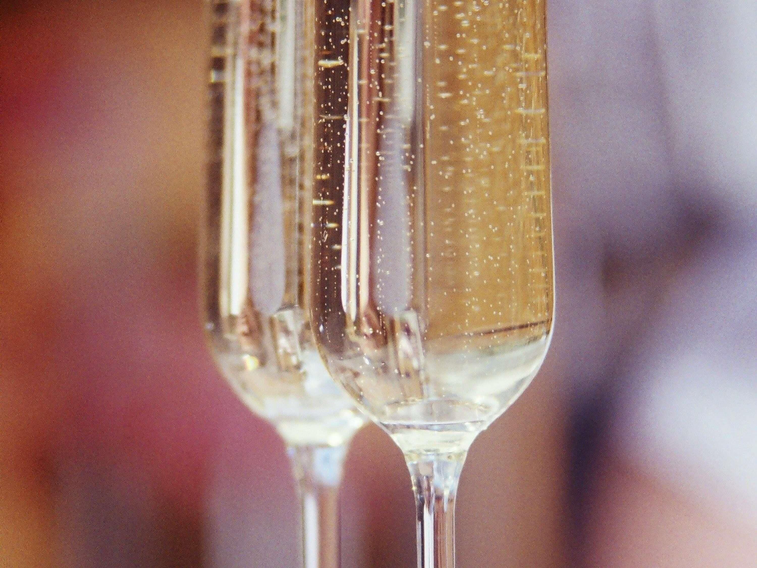 A close-up of a champagne glass with bubbles.