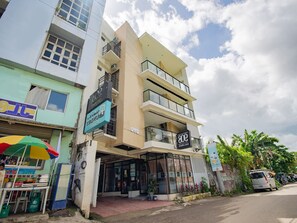 A multi-story building with a ground-level commercial space, a visible entrance, and a balcony. - OYO 707 908 Salinas Suites (Cebu City)