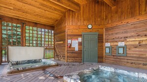 A wooden cabin with two hot tubs and a door. - The Pines 202 2 Bedroom Condo by RedAwning (Steamboat Springs)