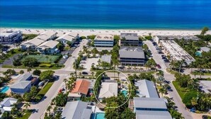 A coastal hotel with multiple buildings, a beach, and a swimming pool. - Coccoloba 3 Bedroom Home by RedAwning (Holmes Beach)