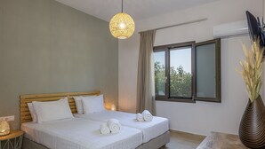 A modern bedroom with a large bed, a bedside table, a lamp, and a window with curtains. - Mithonies Villa, with Private Pool & BBQ, Walking distance to shops (Rethymno)