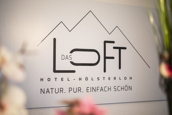 A sign for "Das LOFT Hotel-Holsterloh" with a mountain design and the tagline "Natur. Pur. Einfach Schön." - DAS LOFT Hotel Hölsterloh (Brilon)