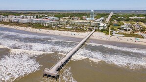 A coastal area with a long pier extending into the water, surrounded by buildings and a beach. - Sea Cabin 208 | 1 Bedroom Oceanfront Condo | Pool | Just Renovated (Isle of Palms)
