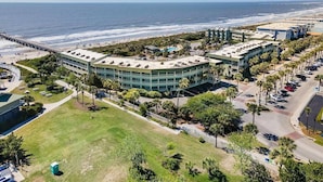 An aerial view of a coastal hotel with a beach view, a parking lot, and a pedestrian walkway. - Sea Cabin 208 | 1 Bedroom Oceanfront Condo | Pool | Just Renovated (Isle of Palms)