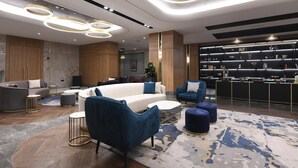 A modern lobby with a reception desk, sofas, and a patterned rug. - Crowne Plaza Ankara by IHG (Ankara)
