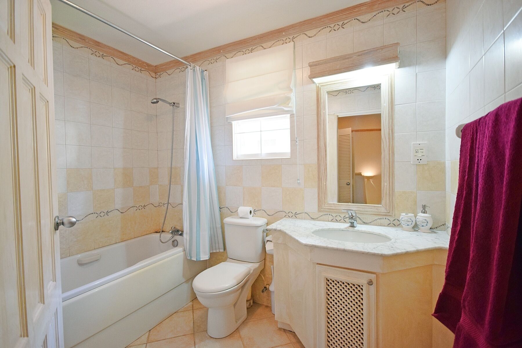 A bathroom with a bathtub, toilet, and sink.