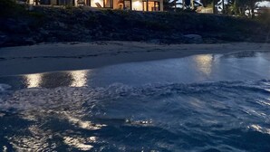 A beachfront property with a large house, a covered patio, and a sandy beach. - IslandChicBeachFrontHome!StunningViews-Pool,OutdoorKitchen,Reef,Mini BballCourt (Rokers Point Settlement)