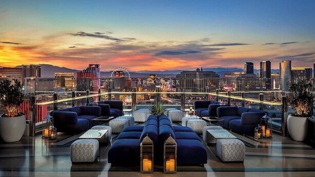 A rooftop lounge with multiple seating areas, a city skyline view, and a modern design. - Immaculate Views in Las Vegas High Rise Corner Unit  (Las Vegas)