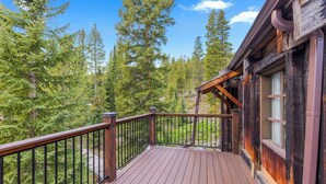 A wooden deck with a railing, surrounded by tall trees. - Brecken Haus (Breckenridge)