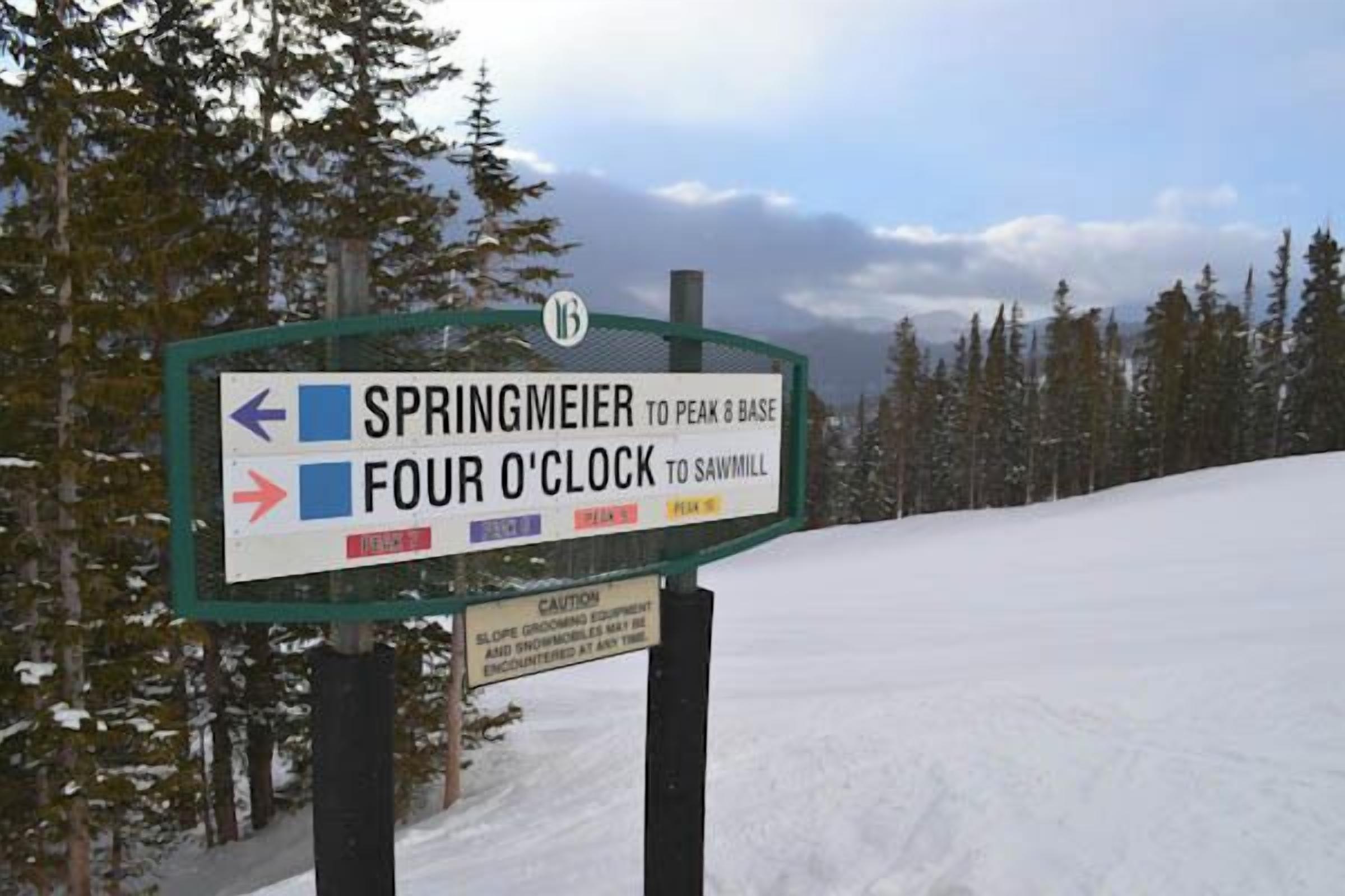A directional sign with arrows pointing to Springmeier and Four O'Clock.
