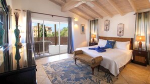 A bedroom with a large bed, a ceiling fan, a view to the outside, and a balcony. - Modern 2-bed Apt Near Beach In St. Lawrence Gap 2 Bedroom Apts by Bluescape (St. Lawrence Gap)