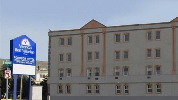 A multi-story hotel with a classic architectural design, featuring a prominent sign for the Fordson Hotel. - Americas Best Value Inn-detroit/dearborn (Dearborn)