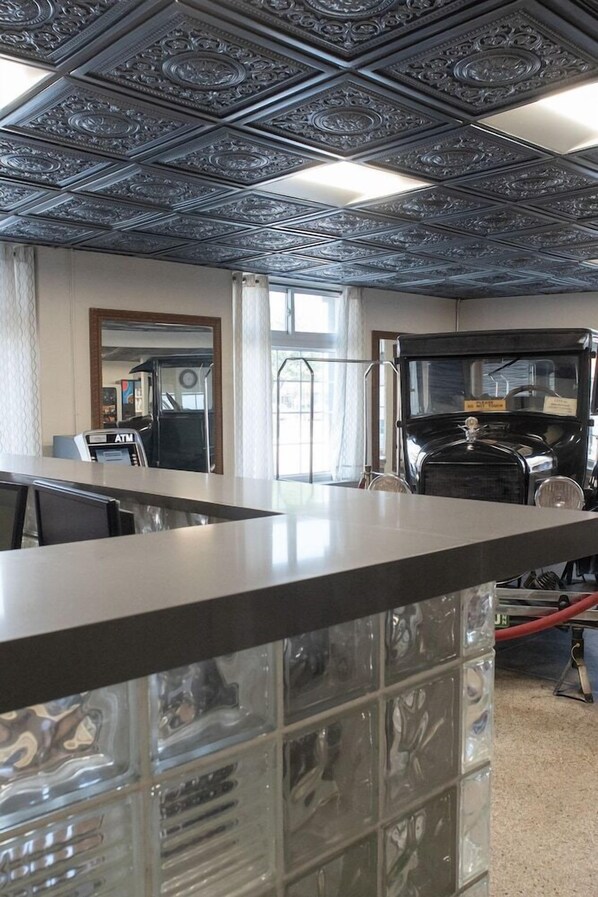 A bar area with a vintage car and a cash register. - Hotel Chataura (Dearborn)
