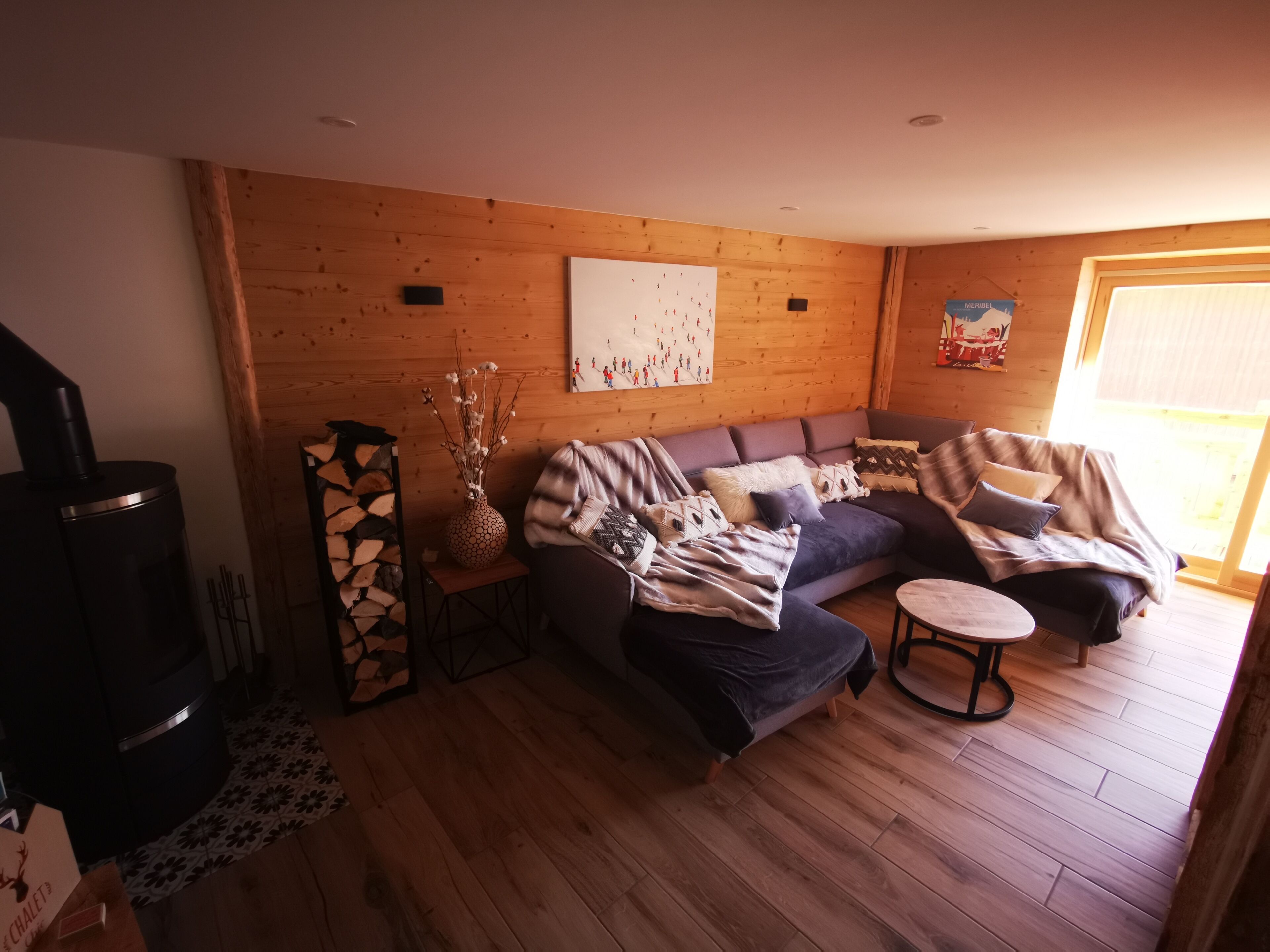 A cozy living room with a sofa, a small table, and a fireplace.