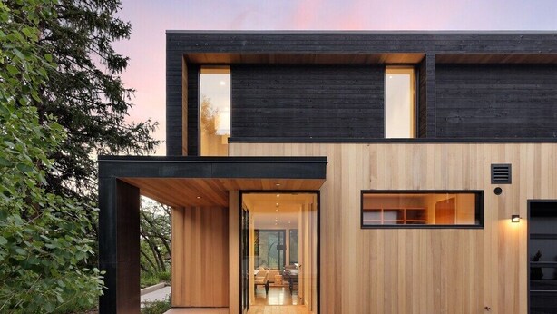 A modern two-story building with a combination of dark and light wooden panels, large windows, and a covered entrance area. - $7 Million Aspen 4BR Residence - Brand New Construction (Aspen)