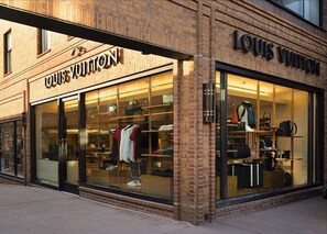 A Louis Vuitton store with large glass windows displaying clothing and accessories. - New Luxury Aspen Home by Aspen Vacation Rentals™ (Aspen)
