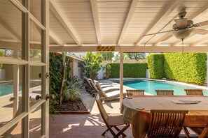 A covered patio with a pool, outdoor furniture, and a 'Watch Your Step' sign. -  PICTURE PERFECT minutes to UNIVERSAL STUDIOS & HOLLYWOOD: Rated 10/10!!! (Los Angeles)