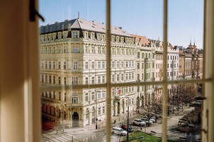 A historic building with classical architecture, large windows, and a central courtyard.