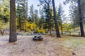 Outdoor dining - Riverfront ground-floor apartment with patio & lovely yard - dog-friendly (Joseph)