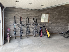 A garage with bicycles and a bench.
