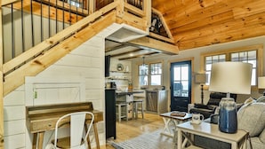 A wooden interior with a staircase, kitchen, and seating area. - What A View | Ellijay, GA (Ellijay)