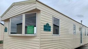 A mobile home with a sign indicating it is a Holiday Maker Special.