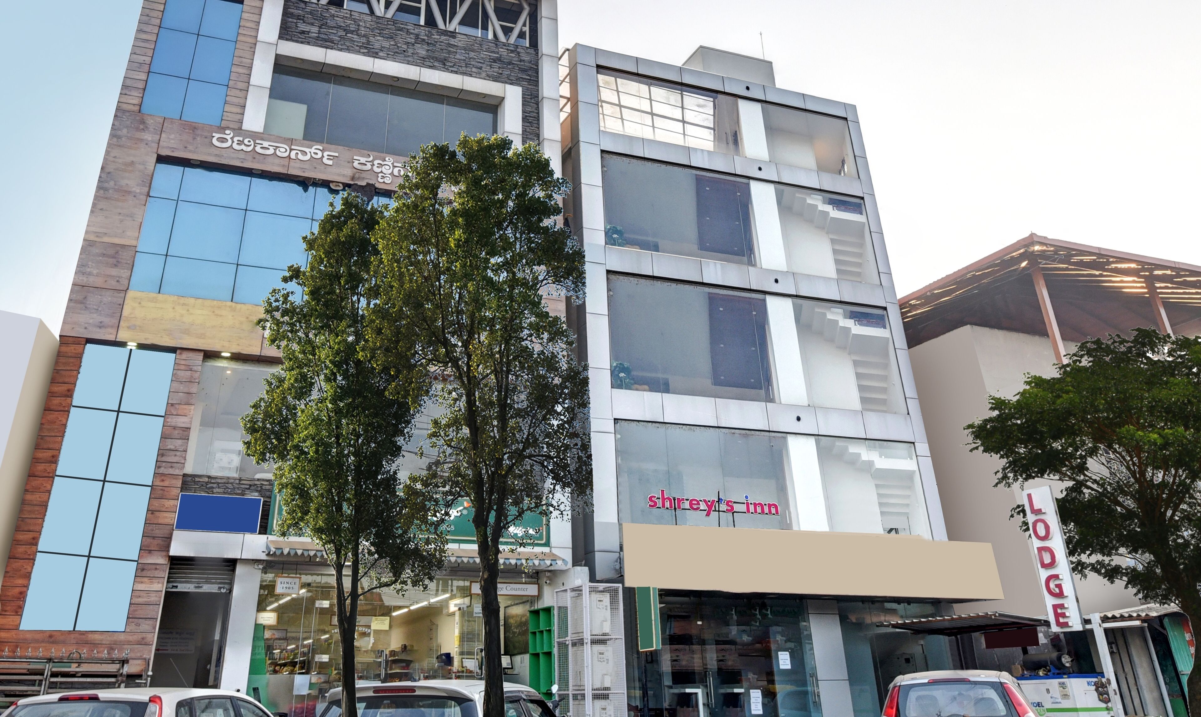 A multi-story building with a 'Shrey's Inn' sign on the ground floor.