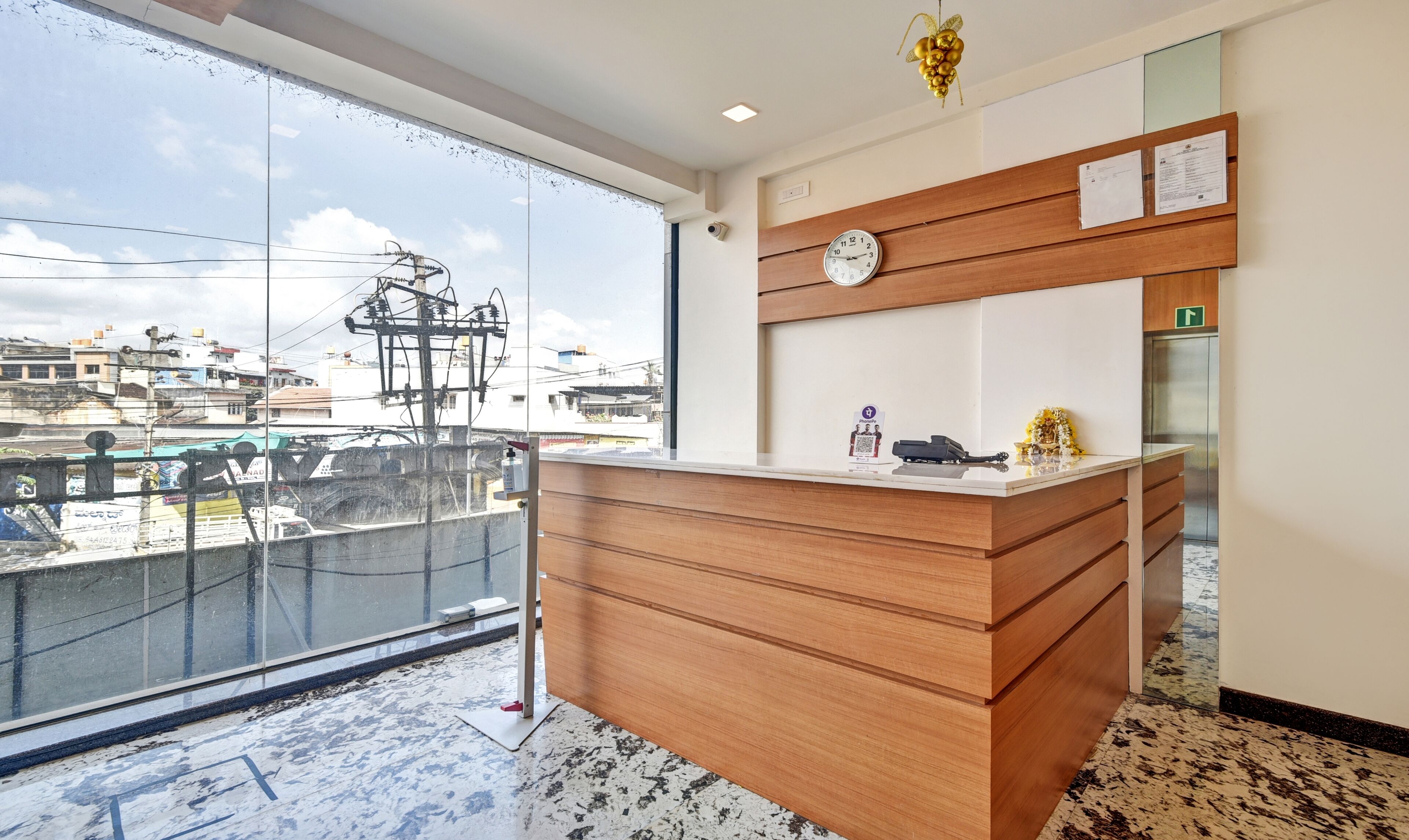 A hotel reception desk with a large window overlooking a construction site.