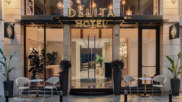 The exterior of Delita Hotel with a modern facade, large windows, and outdoor seating area. - Delita City Hotel (Istanbul)
