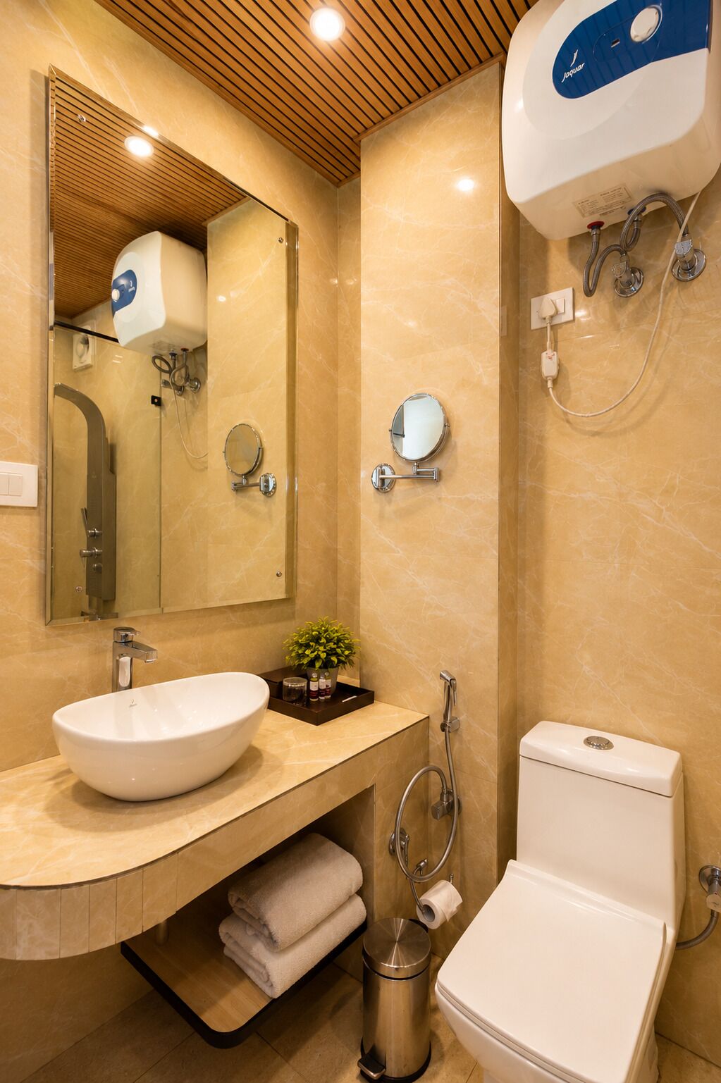 A modern bathroom with a vanity, sink, mirror, towel rack, toilet, and shower.