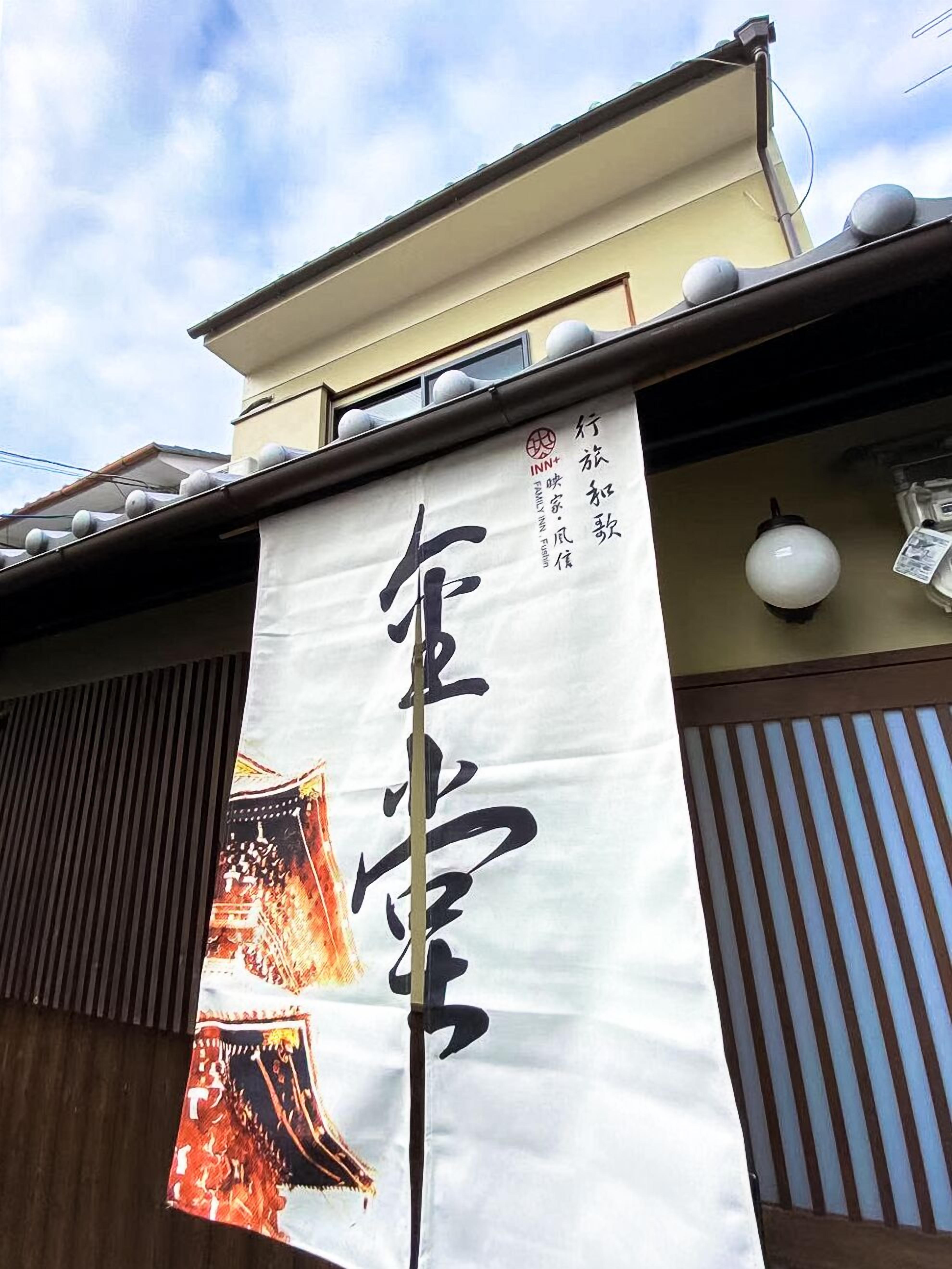 Um edifício com uma grande faixa branca exibindo caracteres japoneses.