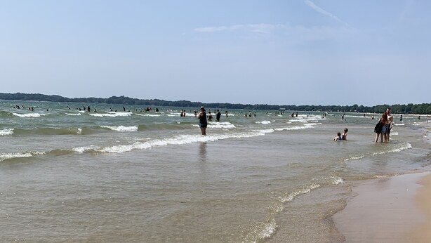 A beach with clear shallow waters and a sandy shore. - The York House (Fort Erie)