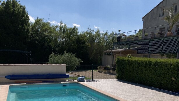 A rectangular swimming pool with clear blue water, surrounded by a tiled deck. - Gite Campanula with communal swimming pool (Saint-Rémy-de-Provence)