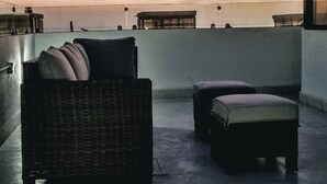 A balcony with wicker furniture and a view of the sunset. - 🌄Papas&Beer✔️ PuertoNuevo✔️ Valle ✔️ Ensenada✔️ (Rosarito)
