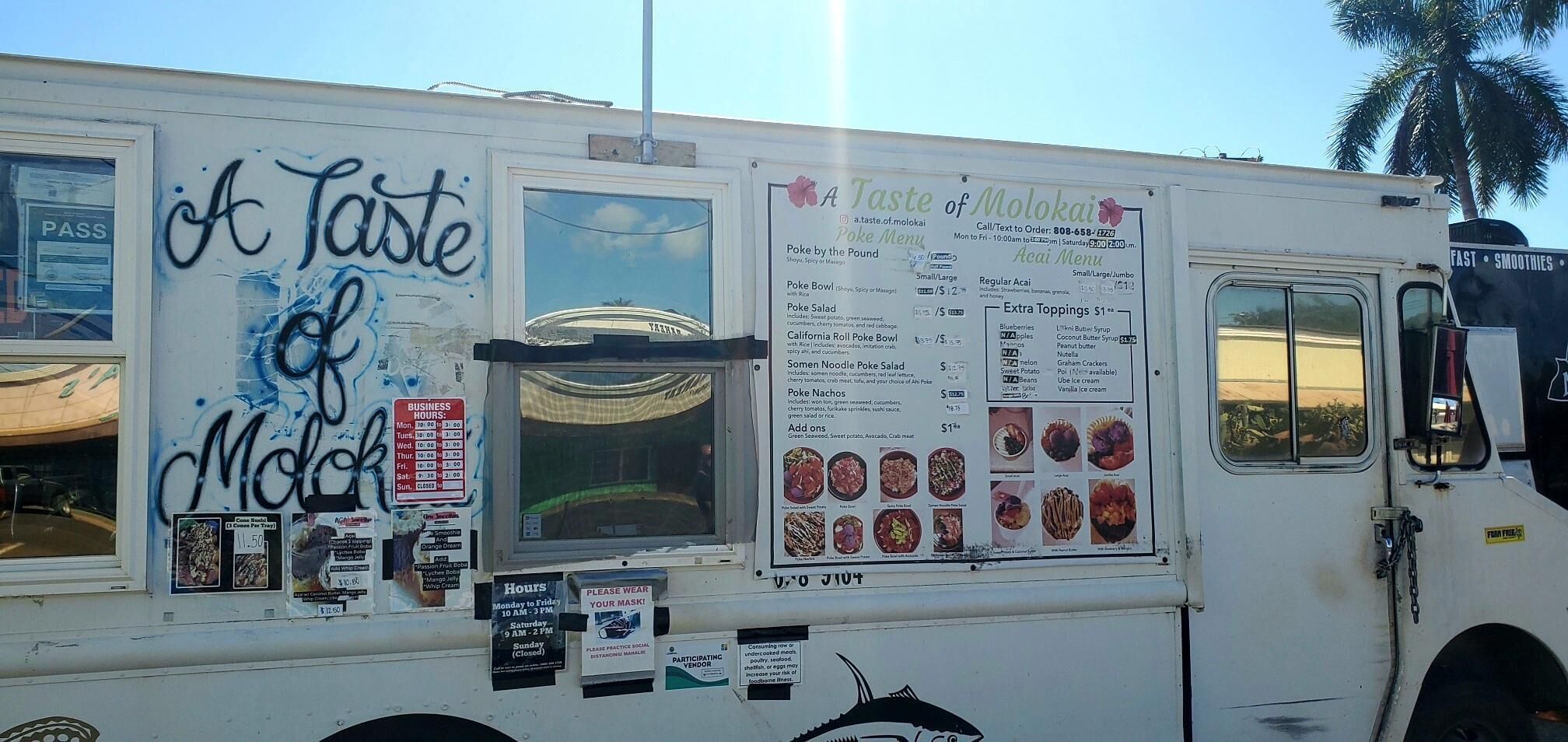 A food truck with a menu board displaying various poke dishes and business hours.