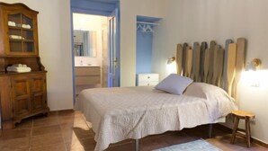 A bedroom with a bed, a wooden dresser, a mirror, and a nightstand. - Canton Balin by Interhome (Meina)