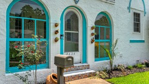 A white building with turquoise window frames and a mailbox in front. - Norfolk Beach Casita / Fenced Yard / Dog Friendly (Norfolk)