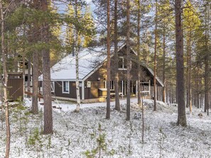 A cabin surrounded by tall trees and snow-covered ground. - Kevinlevi by Interhome (Kittilä)