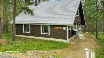 A cabin with a sloped roof, a small porch, and a sign indicating the name 'Kevin's'.