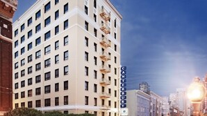 A multi-story hotel with a classic architectural design, featuring a prominent vertical sign with the name 'CANTERBURY' and a 'WYNDHAM' sign below it.