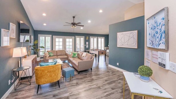 A spacious living room with a high ceiling, a ceiling fan, and a large window providing natural light. - Cozy 3BR Home with Pool & Spa - 9 Mi to LV Strip! (Henderson)