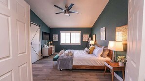 A bedroom with a bed, bedside tables, a ceiling fan, and a window. - Cozy 3BR Home with Pool & Spa - 9 Mi to LV Strip! (Henderson)