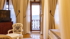 A room with a bed, a chair, a TV, and a balcony with a view. - Rasim Palas (Adults Only +12) (Cesme)
