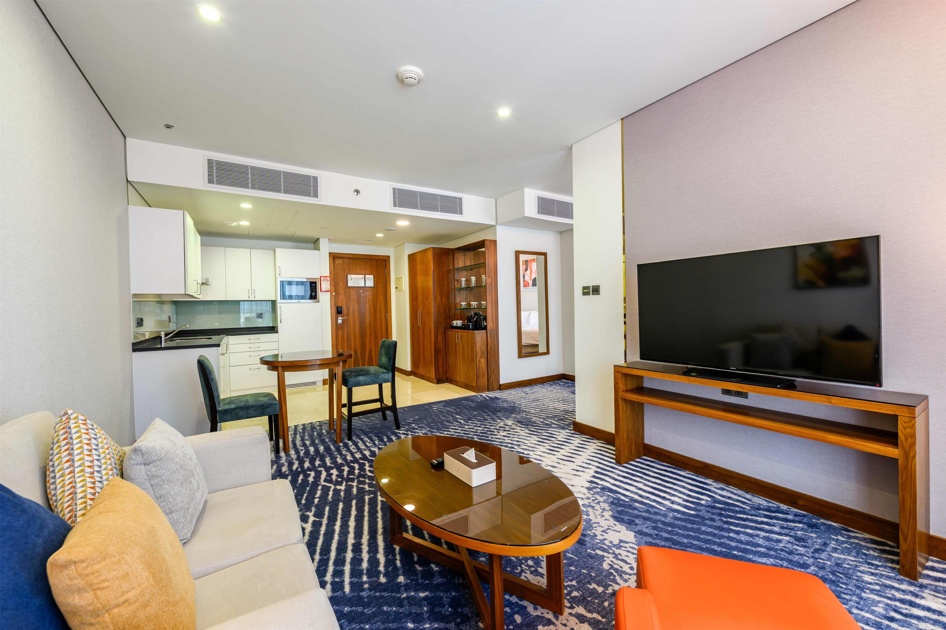 Junior Suite, 1 King Bed (Premium) | Living area | 55-inch flat-screen TV with satellite channels, TV