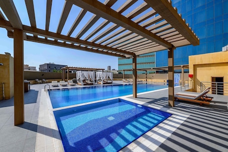 Outdoor pool, pool umbrellas, pool loungers. DoubleTree by Hilton Jeddah Al Andalus Mall