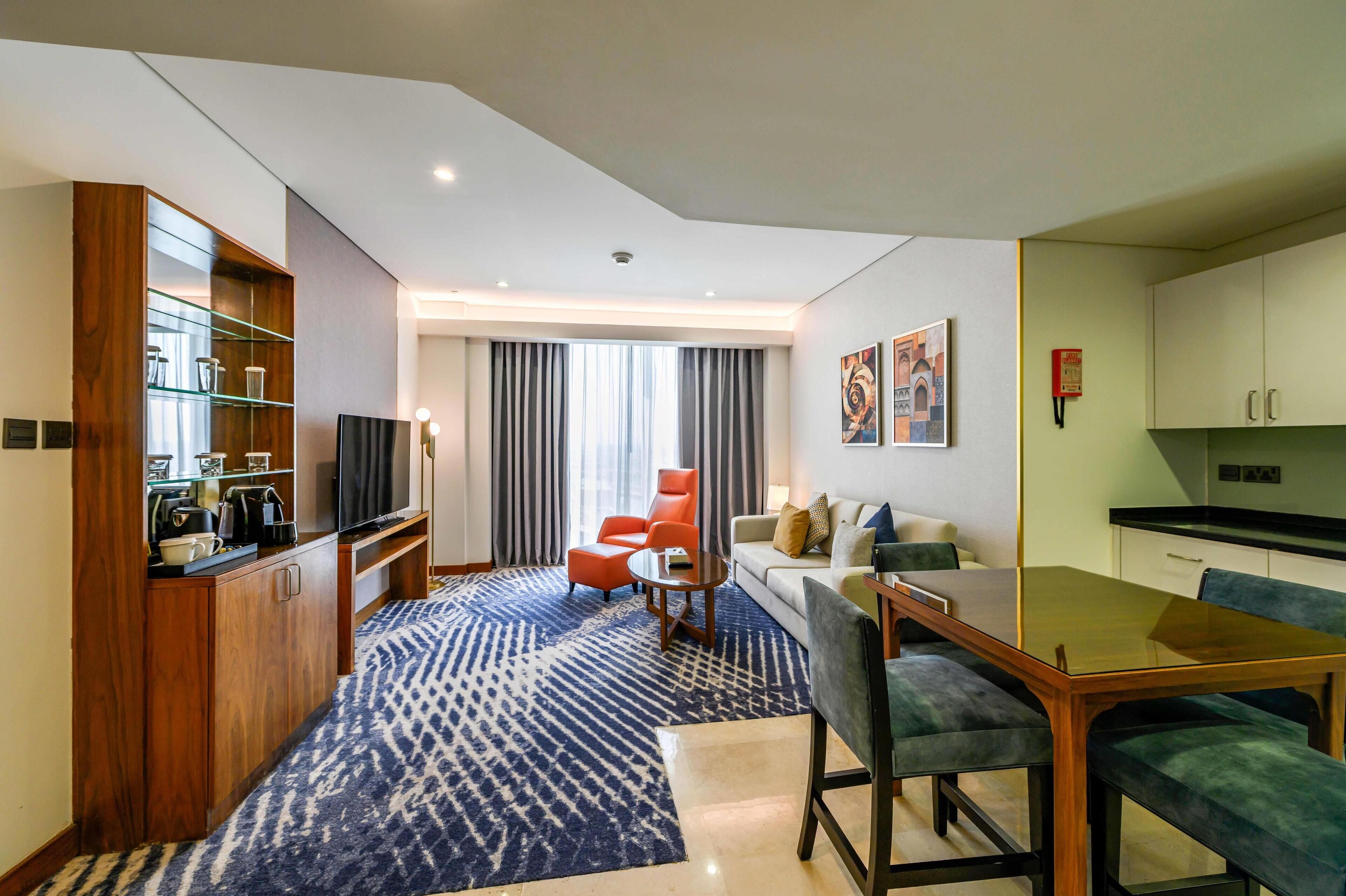 Premium Suite, 1 King Bed | Living area | 55-inch flat-screen TV with satellite channels, TV