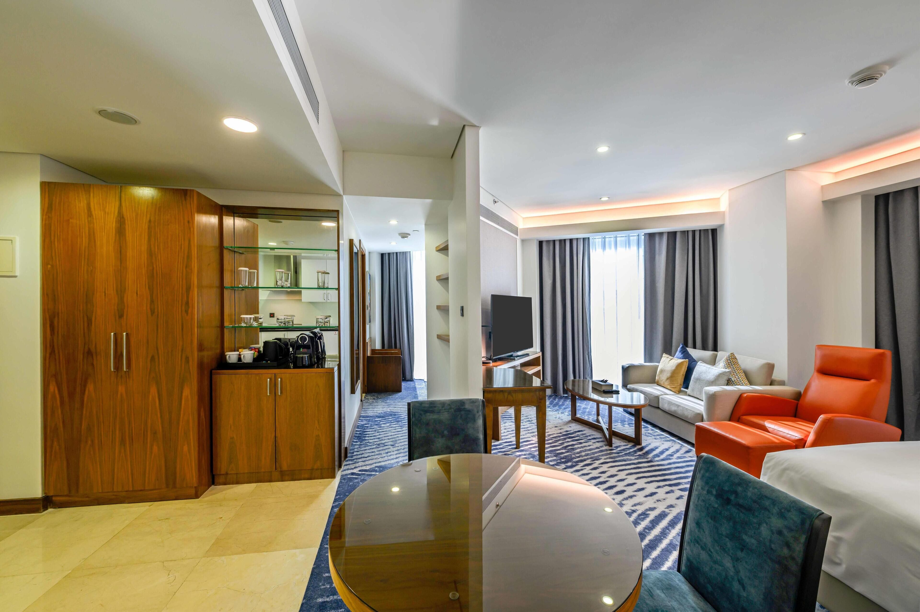 Premium Studio, 1 King Bed | Living area | 55-inch flat-screen TV with satellite channels, TV