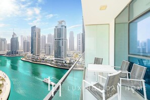 A balcony with a view of a city skyline and water.